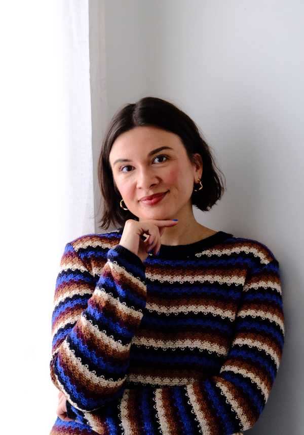 A man and woman facing eachother with foreheads and noses touching smiling